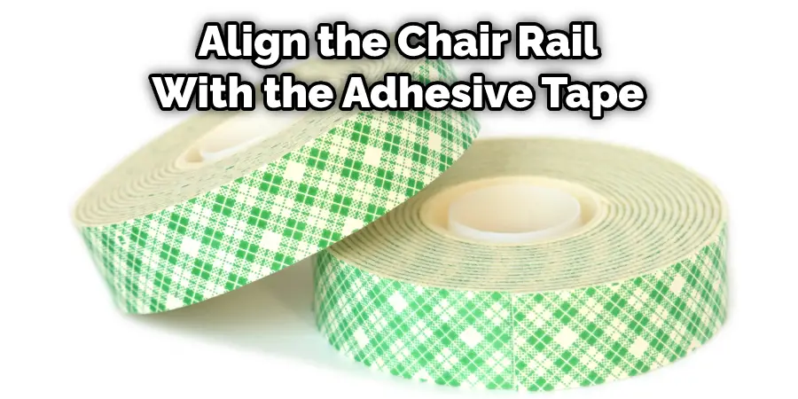 Align the Chair Rail With the Adhesive Tape