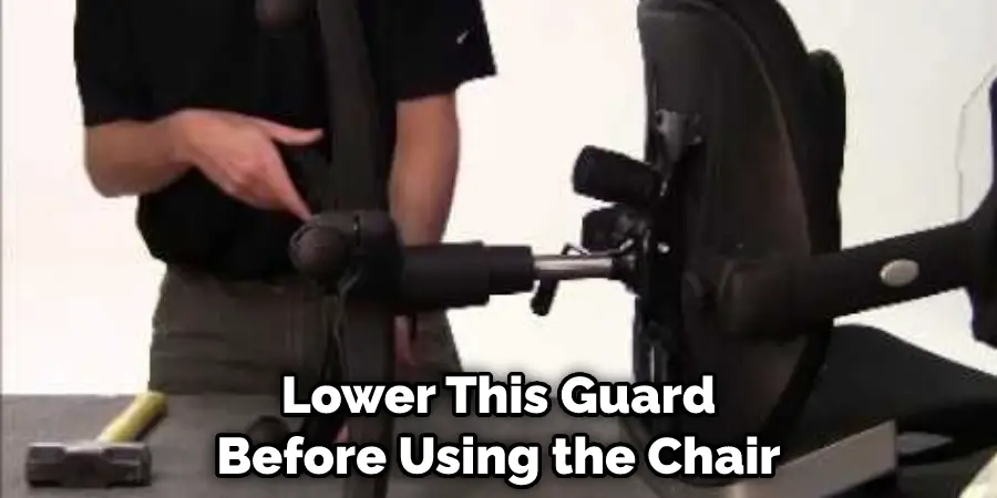Lower This Guard Before Using the Chair