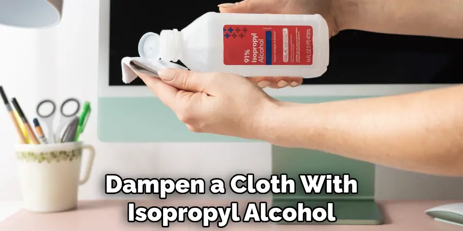 Dampen a Cloth With Isopropyl Alcohol
