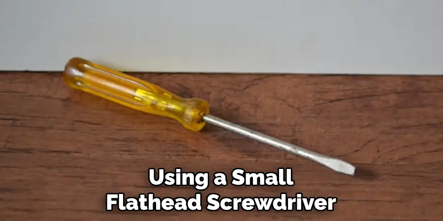 Using a Small Flathead Screwdriver