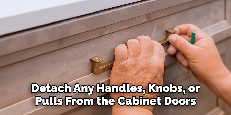 Detach Any Handles, Knobs, or Pulls From the Cabinet Doors