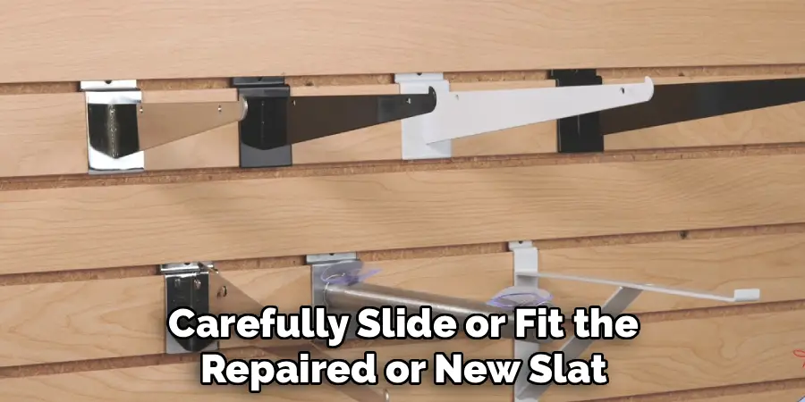 Carefully Slide or Fit the
Repaired or New Slat