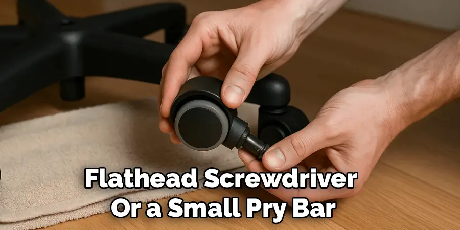 Flathead Screwdriver 
Or a Small Pry Bar