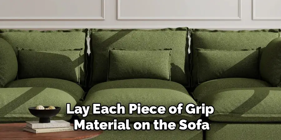 Lay each piece of grip material on the sofa