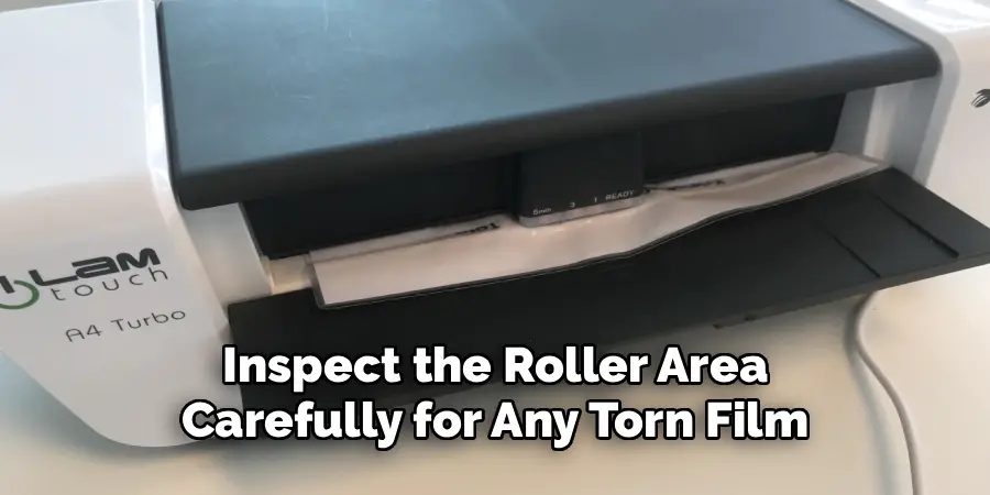 Inspect the Roller Area
Carefully for Any Torn Film